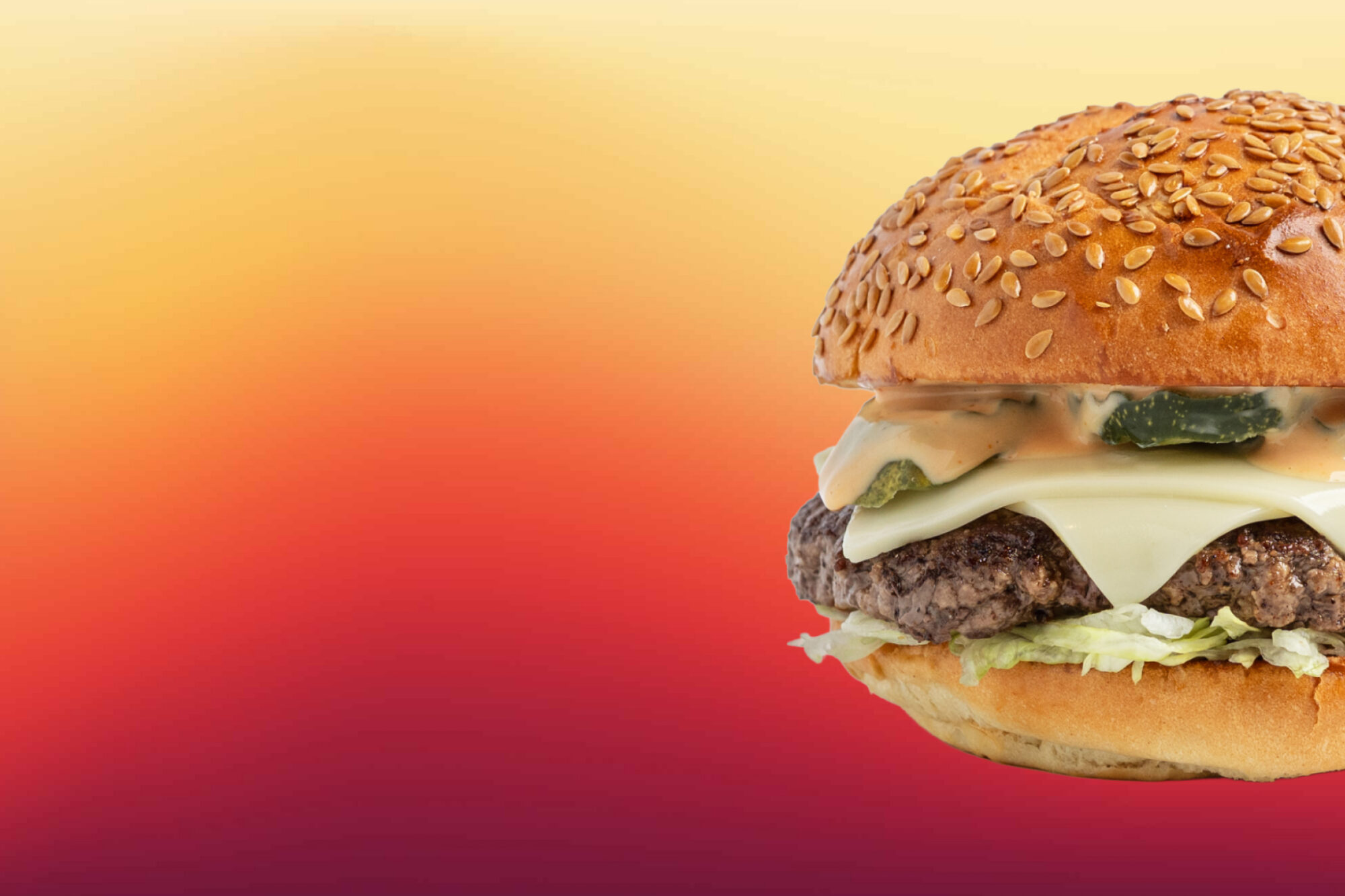 The Rev Burger with melted cheese, pickles, lettuce, and Lightning Sauce on a flax seed bun, set against a warm orange-to-red gradient background