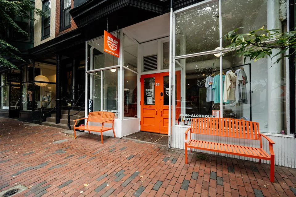 The orange doors and benches outside DRAY’s South End bottle shop